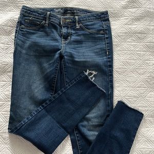 Medium wash denim with frayed detail on cuff